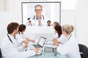 Team Of Doctors Looking At Projector Screen